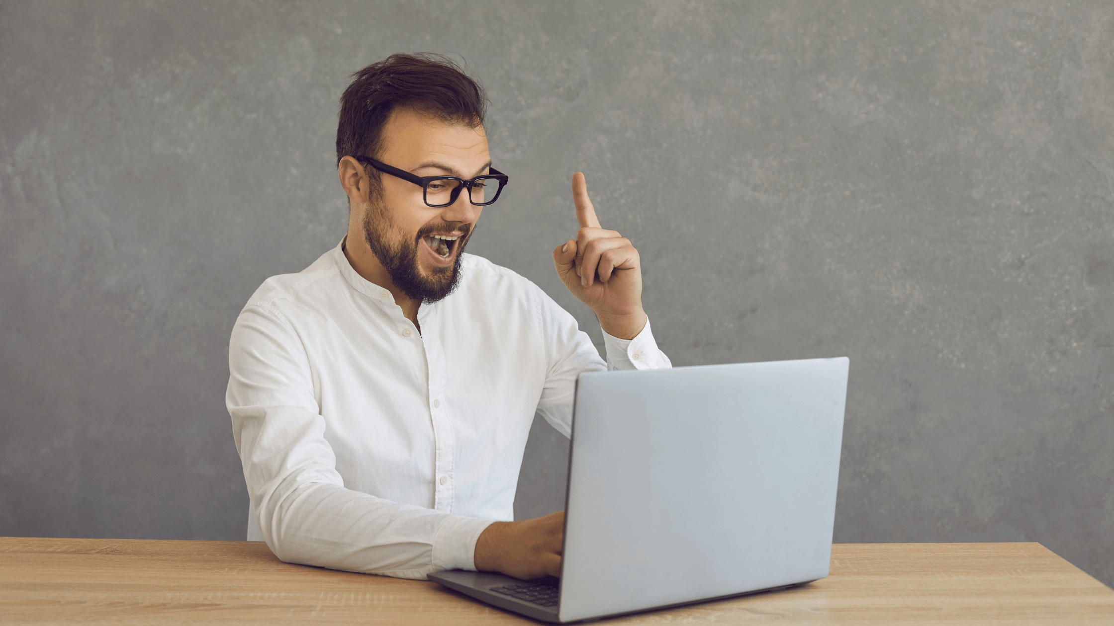 Man in front of laptop gets idea